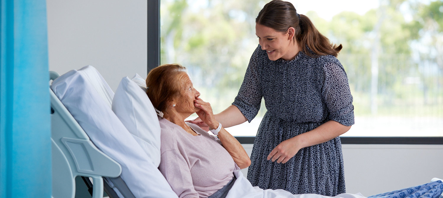 Canberra Health Services team member speaks to patient