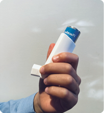 Image of an asthma puffer with arrows pointing down and up to indicate shaking of puffer.