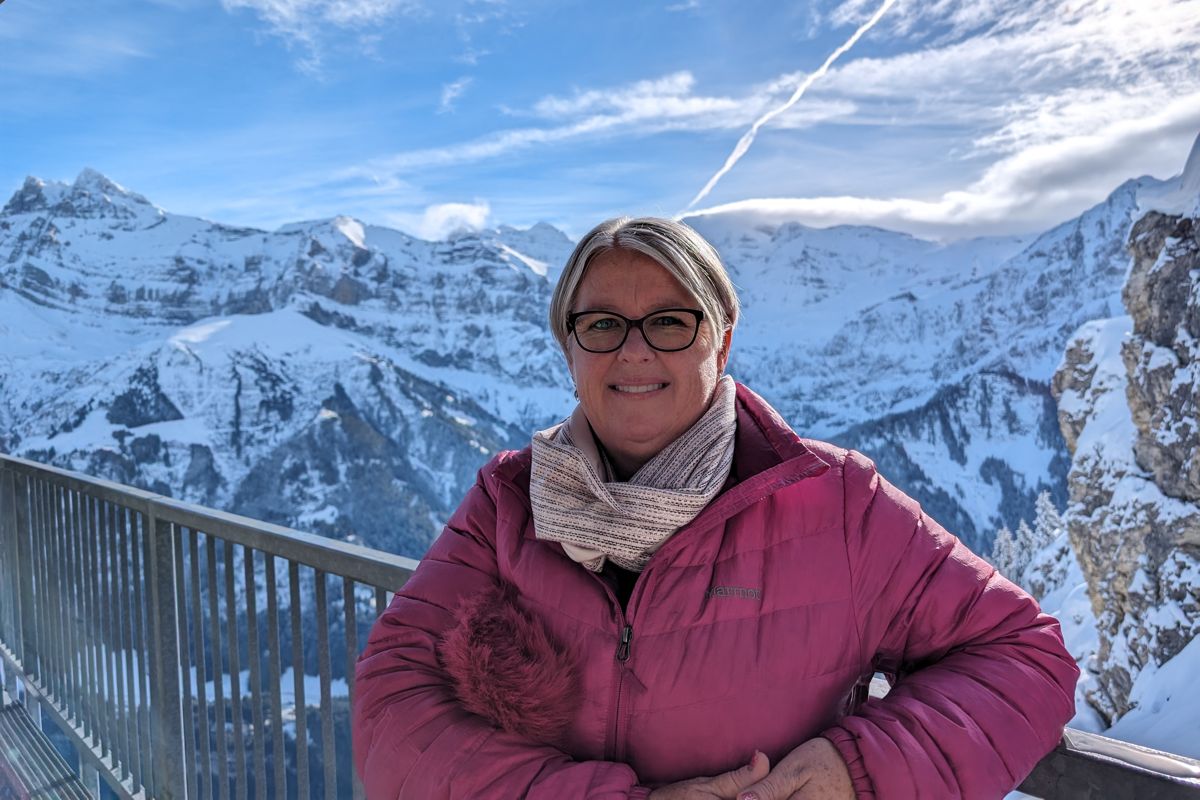 A photo of Kerryn Ernst with snowy mountains behind her