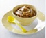 Smooth pureed food in a cup with yellow spoon