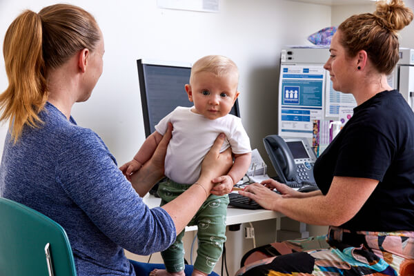 A mum and baby have an appointment with a doctor