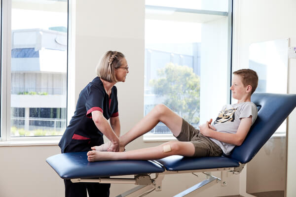 Outpatient appointments A nurse tends to a young boy's ankle