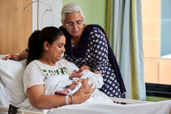 Welcoming a new baby at Centenary Hospital A grandmother admires her daughter and new grandchild