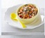 Finely chopped food in a cup with yellow spoon