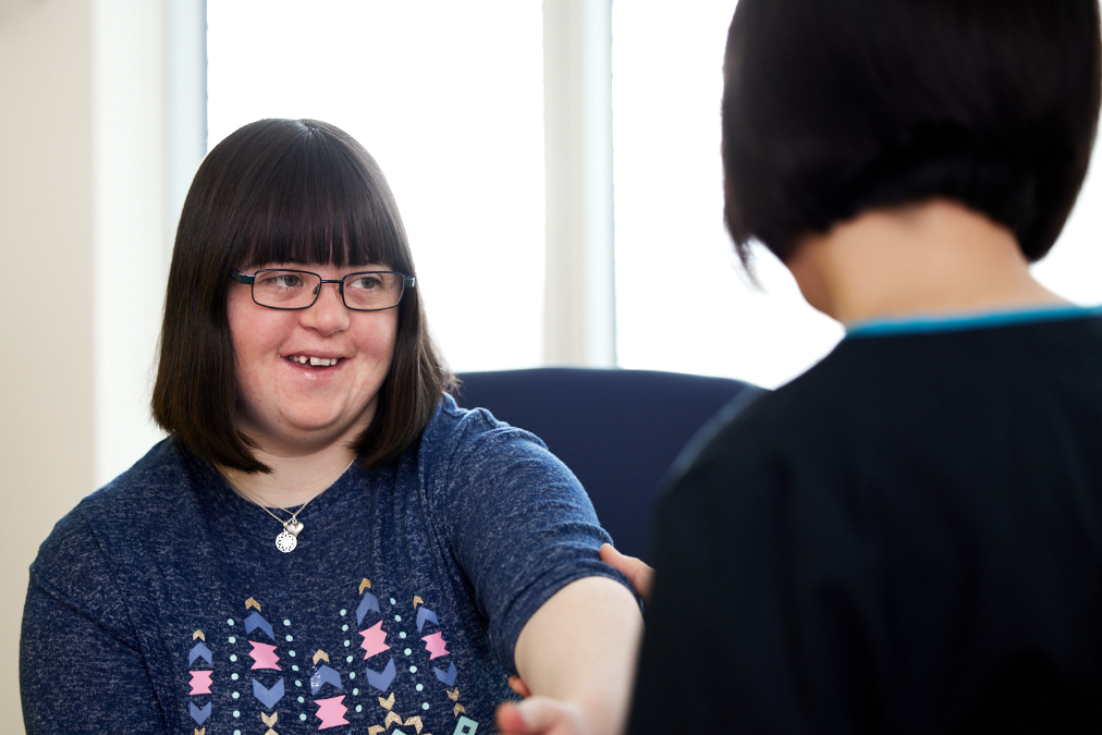 Community nurse attending to a patient with down syndrome
